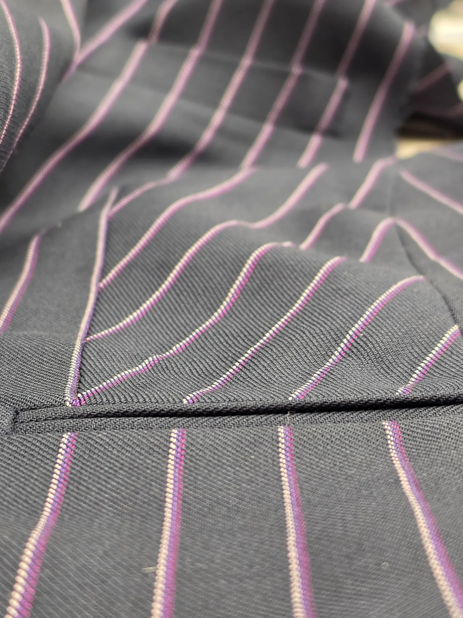 Dark fabric with fine coloured stripes – construction detail
