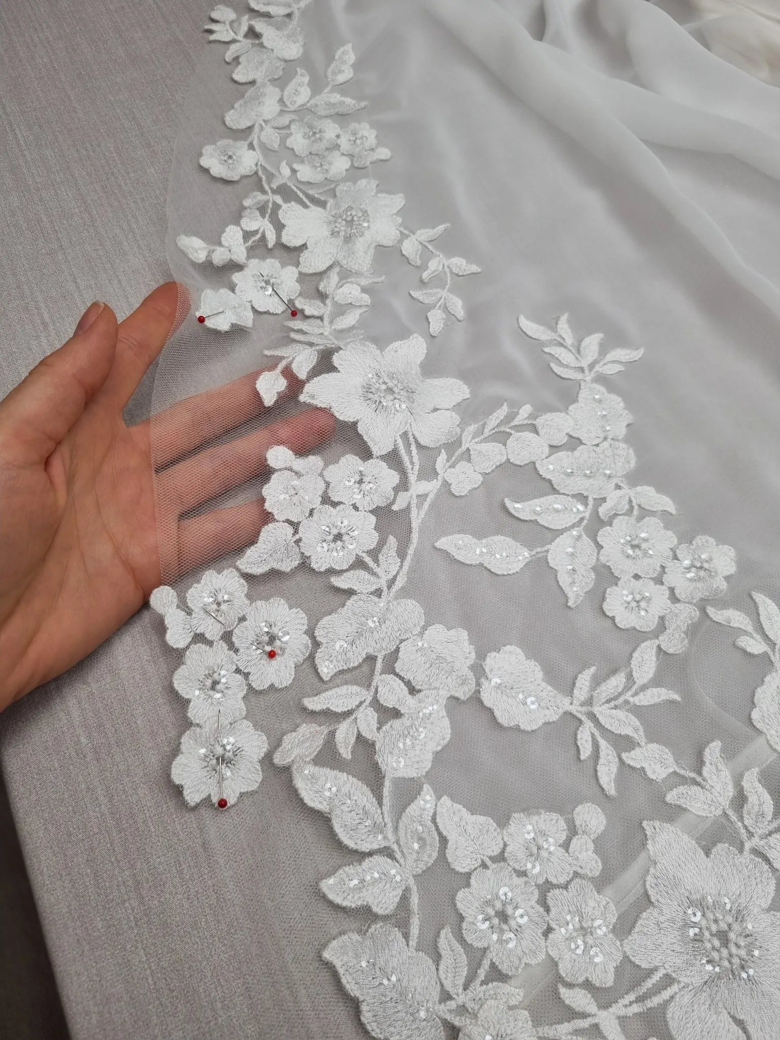 Floral lace being worked by hand